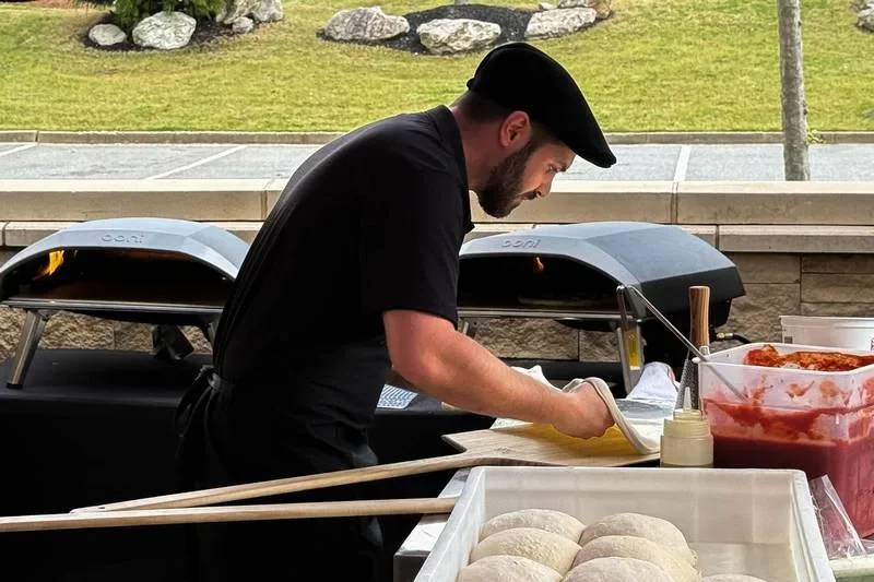 Italian Way chef preparing fresh pizza beside the ovens